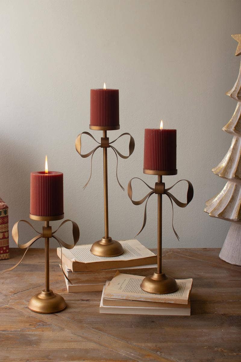 SET OF THREE ANTIQUE BRASS PILLAR CANDLE STANDS -BOW DETAIL: Gold / Metal / Large: 6.25" x 3.5" x 13.25"t;  
Medium: 6.25" x 3.5" x 11"t;  
Small: 6.25" x 3.5" x 8.75"t