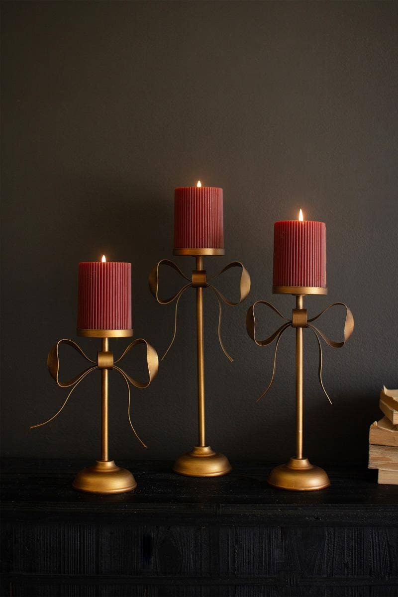SET OF THREE ANTIQUE BRASS PILLAR CANDLE STANDS -BOW DETAIL: Gold / Metal / Large: 6.25" x 3.5" x 13.25"t;  
Medium: 6.25" x 3.5" x 11"t;  
Small: 6.25" x 3.5" x 8.75"t
